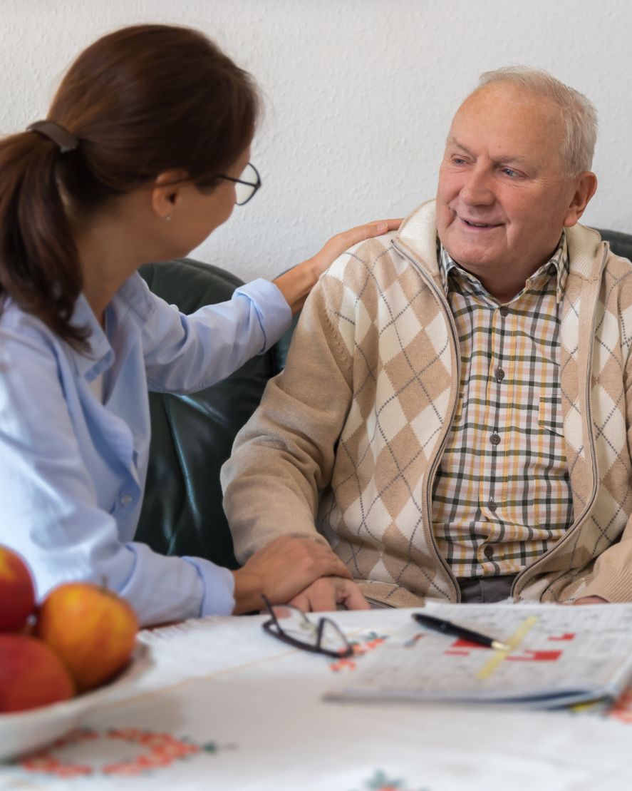 Lady with dark hair having a consultation with an older gentleman